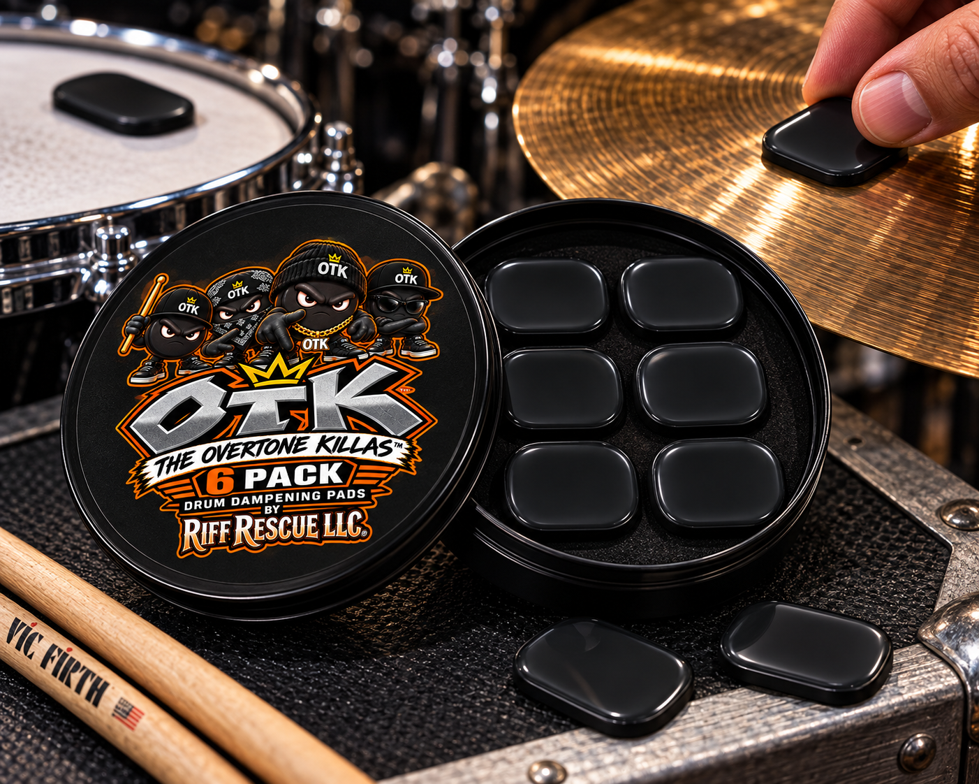 The OTK Overtone Killas tin open on a drum kit, showing six black silicone dampening pads in fitted foam as a player places one on a cymbal.
